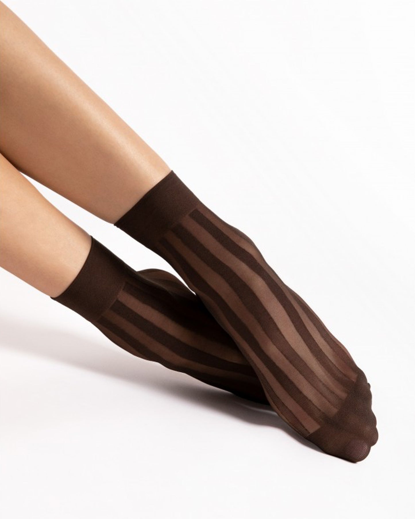 Brown sheer socks worn by a person on a white background