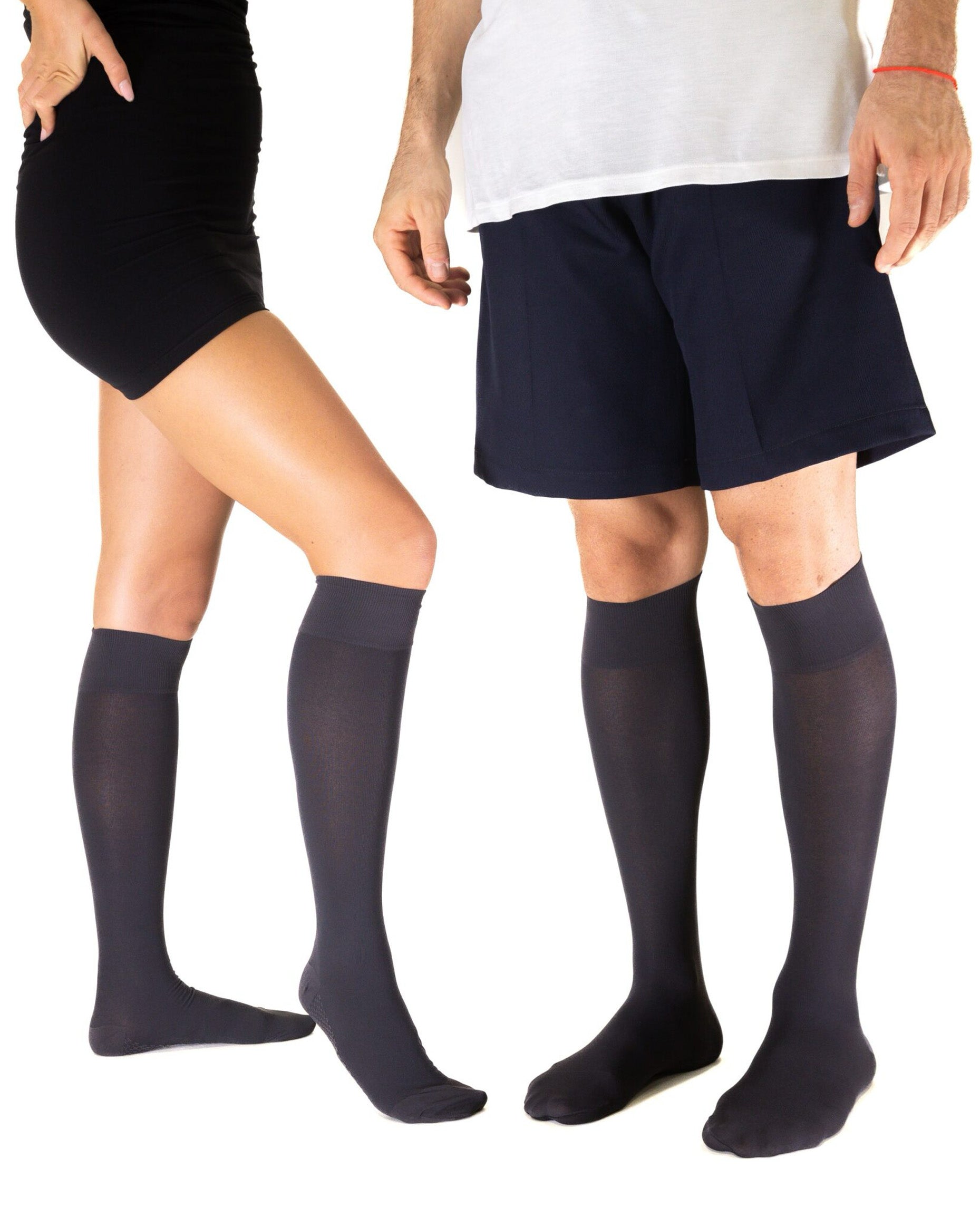 Two people wearing black knee-high socks on a white background
