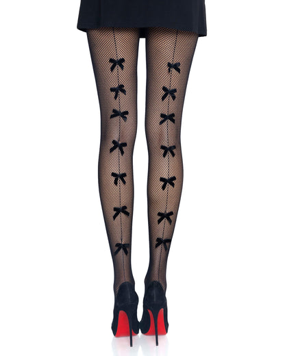 Black fishnet tights with a vertical line of bow-shaped cutouts down the front, shown on a model's legs with black high heels featuring red soles against a white background.
