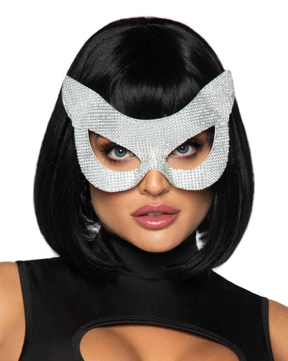 A woman wearing a sparkling silver rhinestone masquerade mask with a cat-ear shape, paired with a black bob wig and a black top against a plain white background.