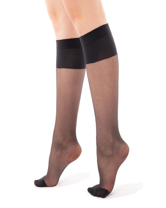 Sheer black knee-high socks worn by a person on a white background
