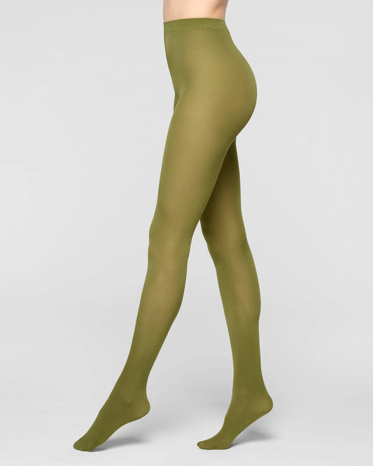 A model's legs wearing solid olive green tights, shown from the waist down in a side profile against a light gray studio background.