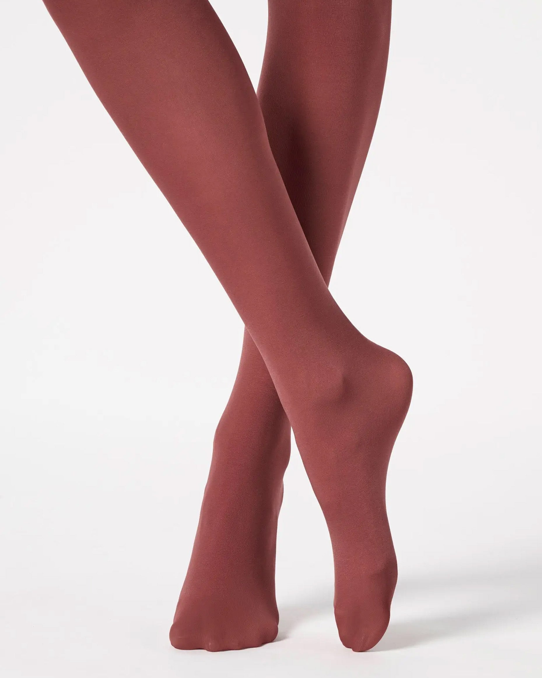 Maroon tights worn by a person on a white background