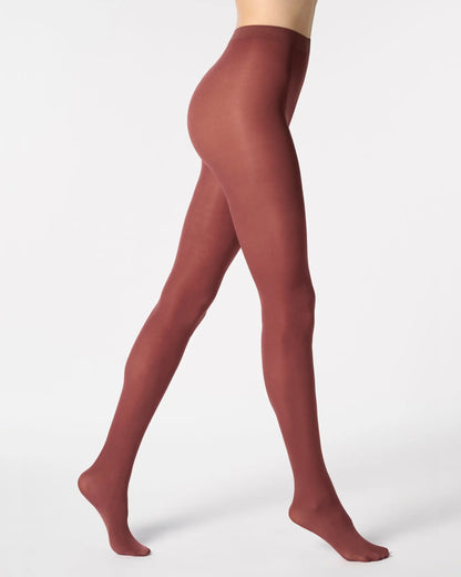 Maroon tights worn by a person on a white background