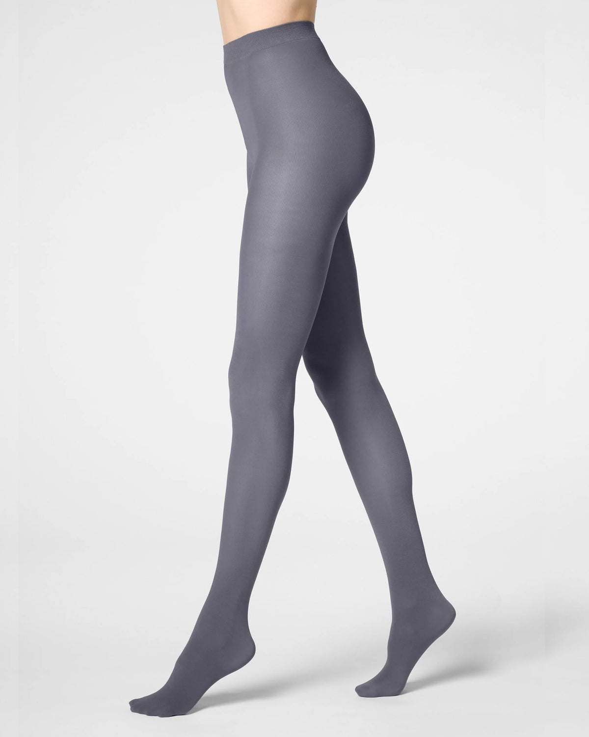 A model's legs wearing a pair of high-waisted, semi-sheer grey tights, shown from a side profile against a light gray studio background.