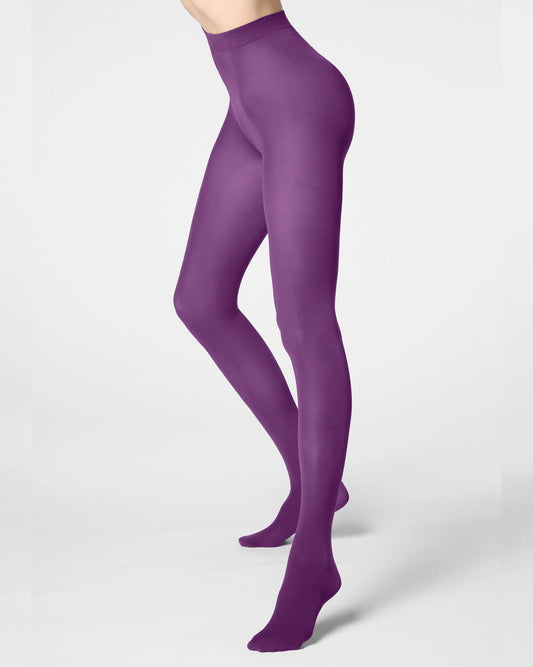A model wearing high-waisted, full-length purple tights, shown from the waist down in a side profile against a light gray studio background.