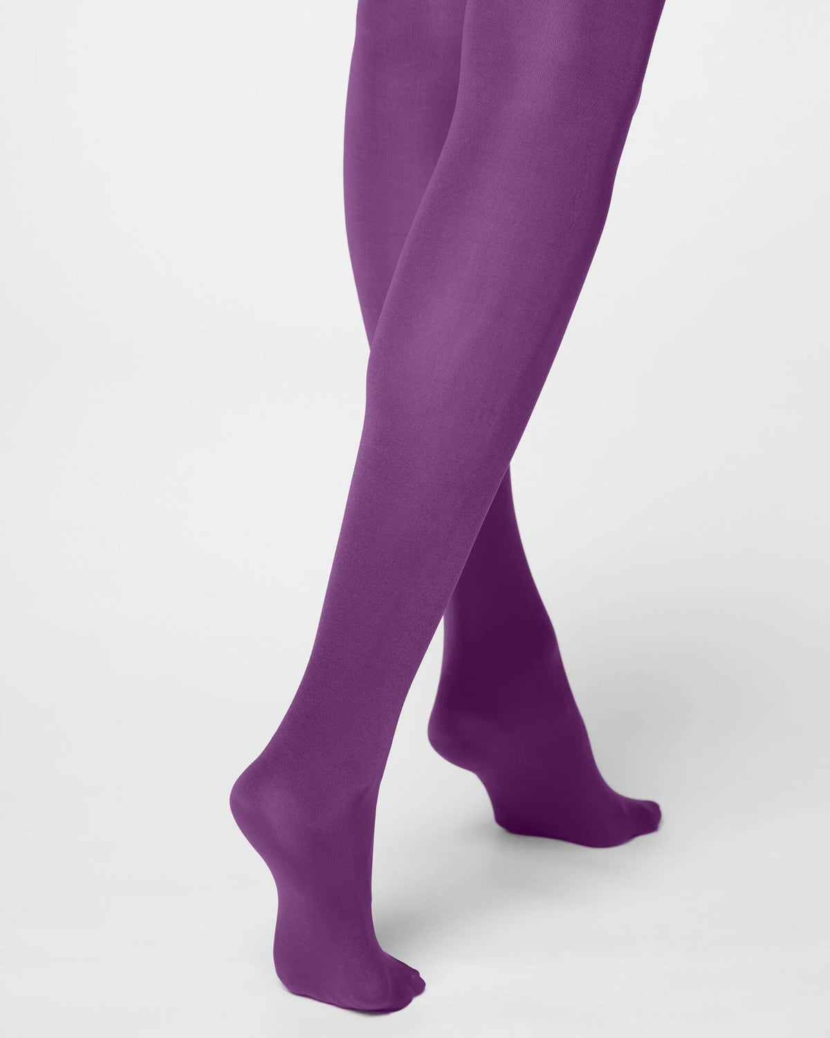 Purple tights worn on a model's legs, shown from the calves down against a clean white studio background.