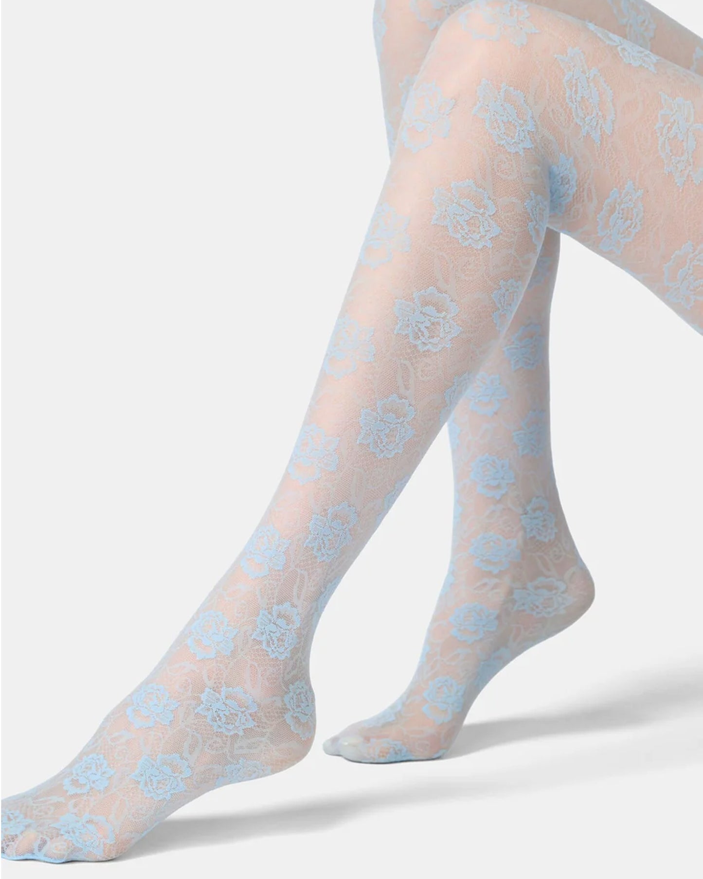 Sheer pastel blue tights with a floral pattern on a white background