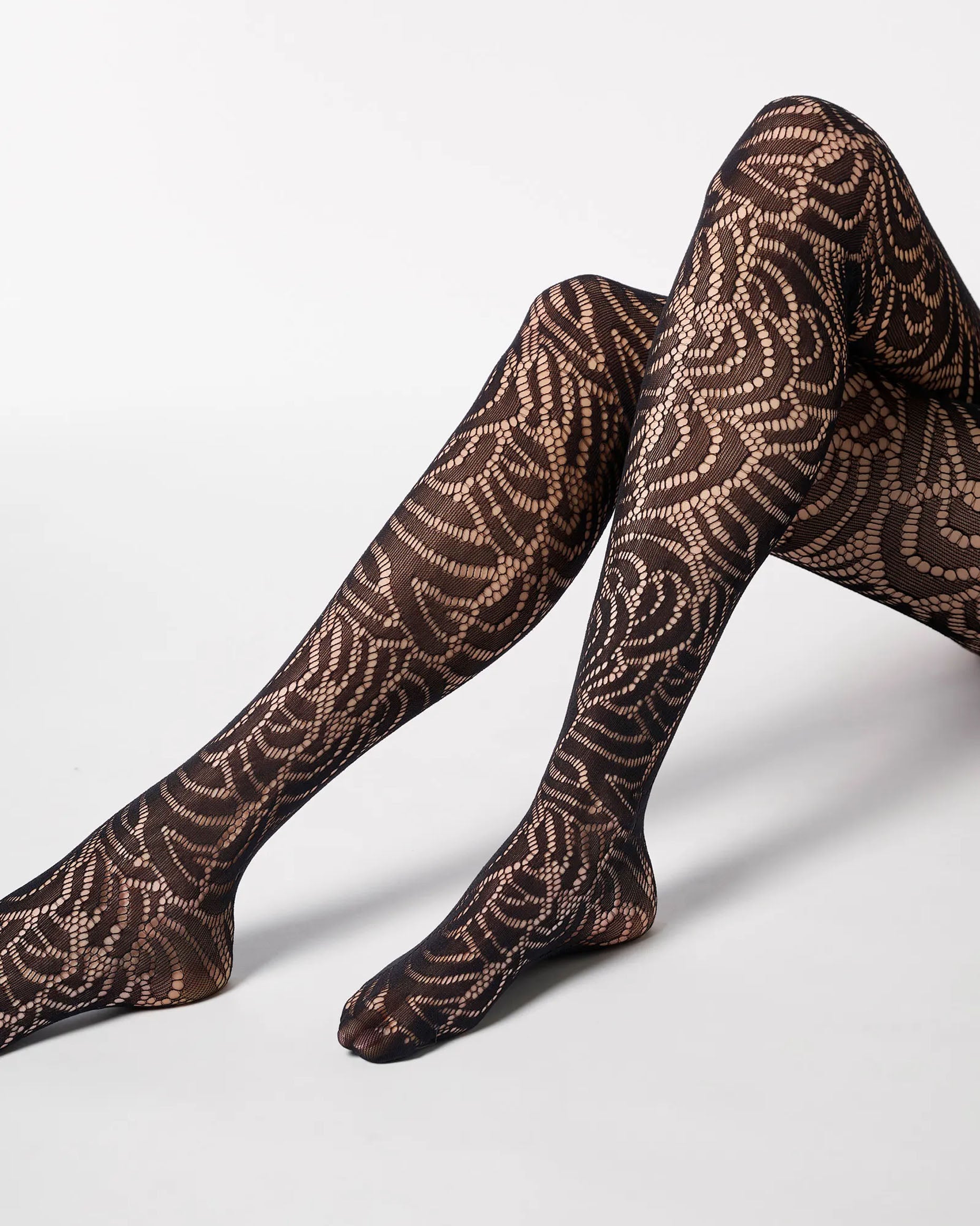 Soft black openwork floral lace style tights with a seamless body.