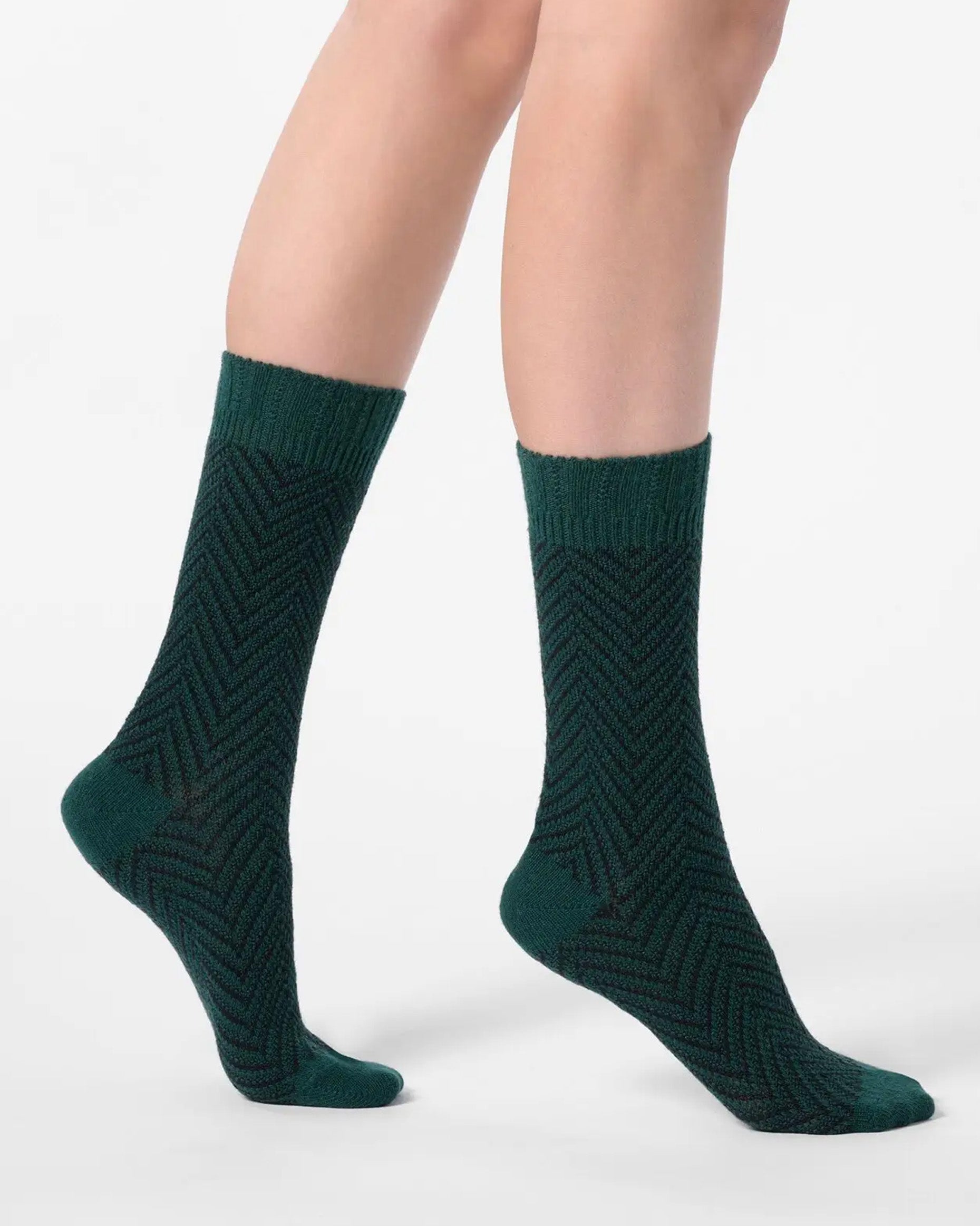 Dark green chunky knitted socks with a black zig-zag pattern