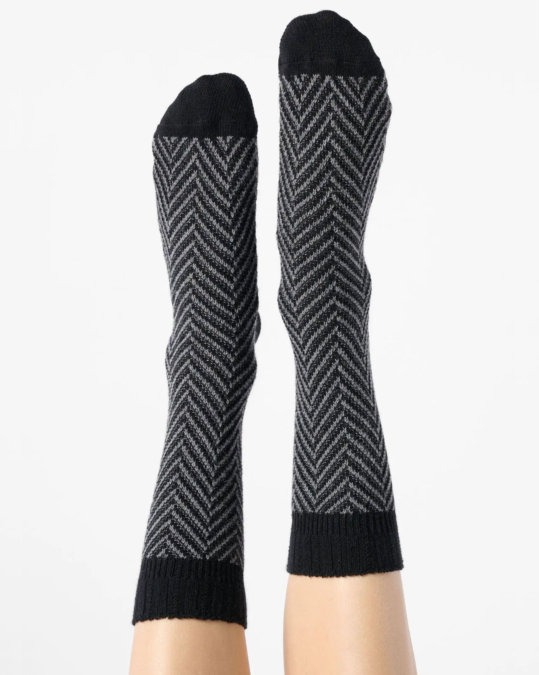 Grey chunky knitted socks with a black zig-zag pattern