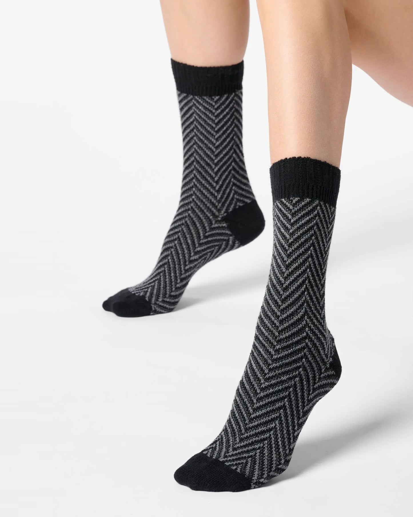 Grey chunky knitted socks with a black zig-zag pattern