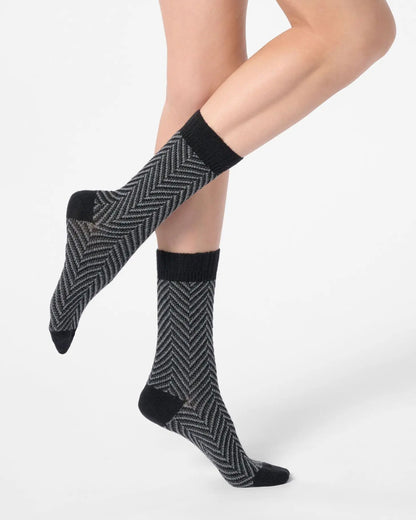 Grey chunky knitted socks with a black zig-zag pattern