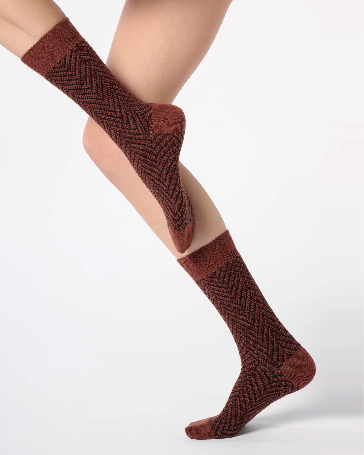 Brick red maroon chunky knitted socks with a black zig-zag pattern