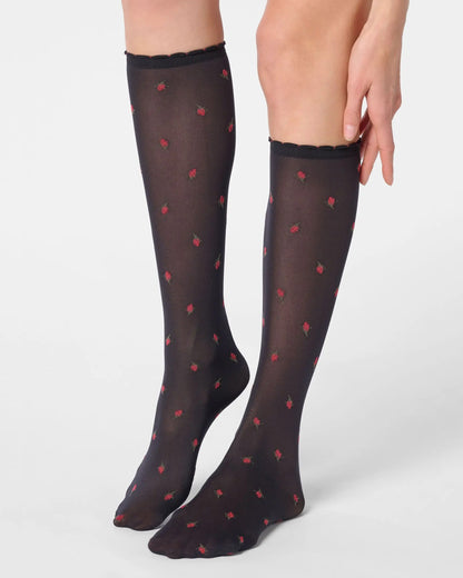 Black semi-opaque knee-high socks with red flower pattern.