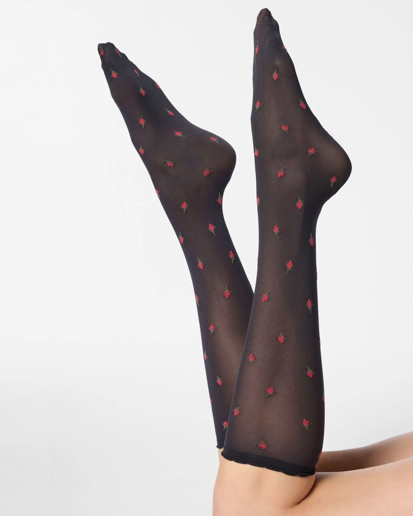 Black semi-opaque knee-high socks with red floral pattern.