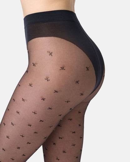 Sheer black tights with a subtle floral pattern on a white background