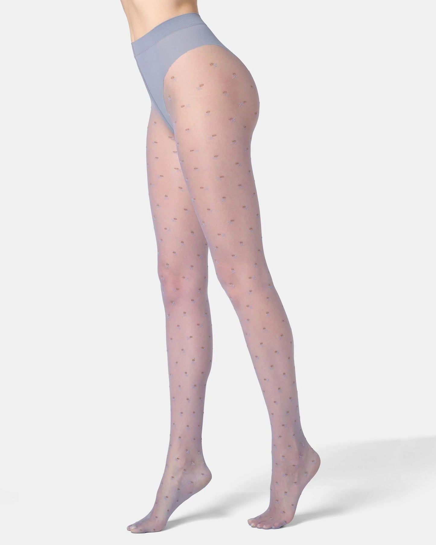 Sheer pale blue tights with a subtle floral pattern worn by a person on a white background