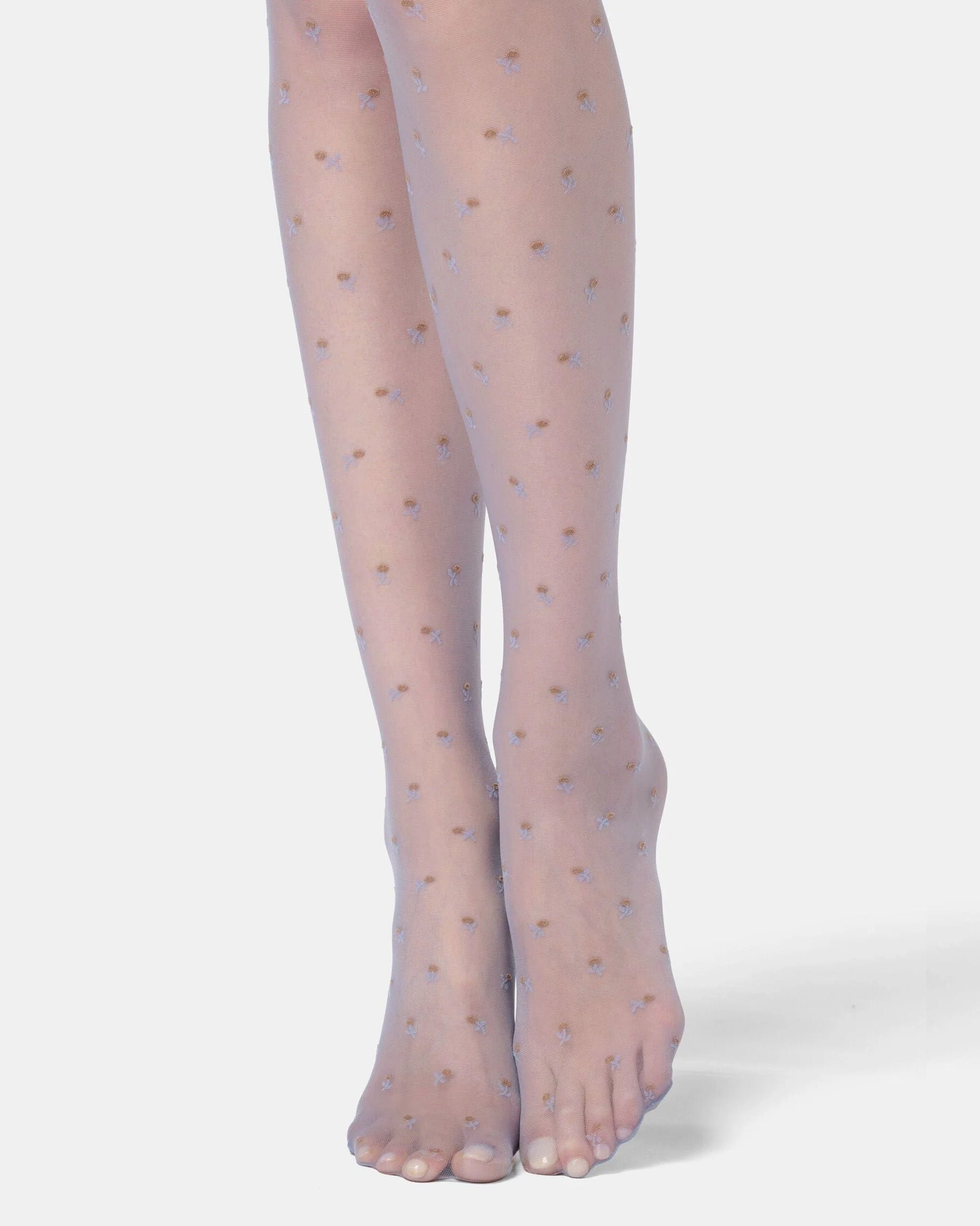 Sheer blue tights with small floral pattern on a white background