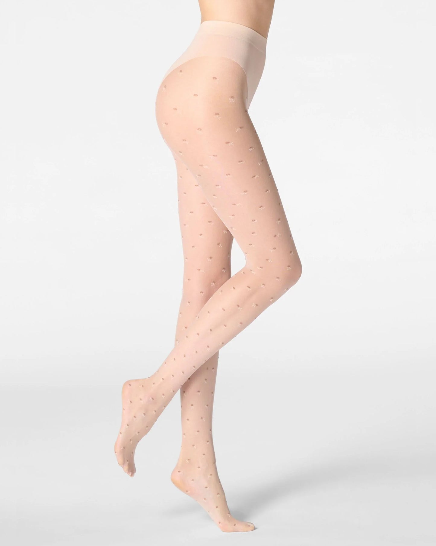 Light nude tights with subtle pattern flower worn by a person on a light grey background