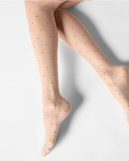 Sheer nude beige tights with small flowers on a light gray background