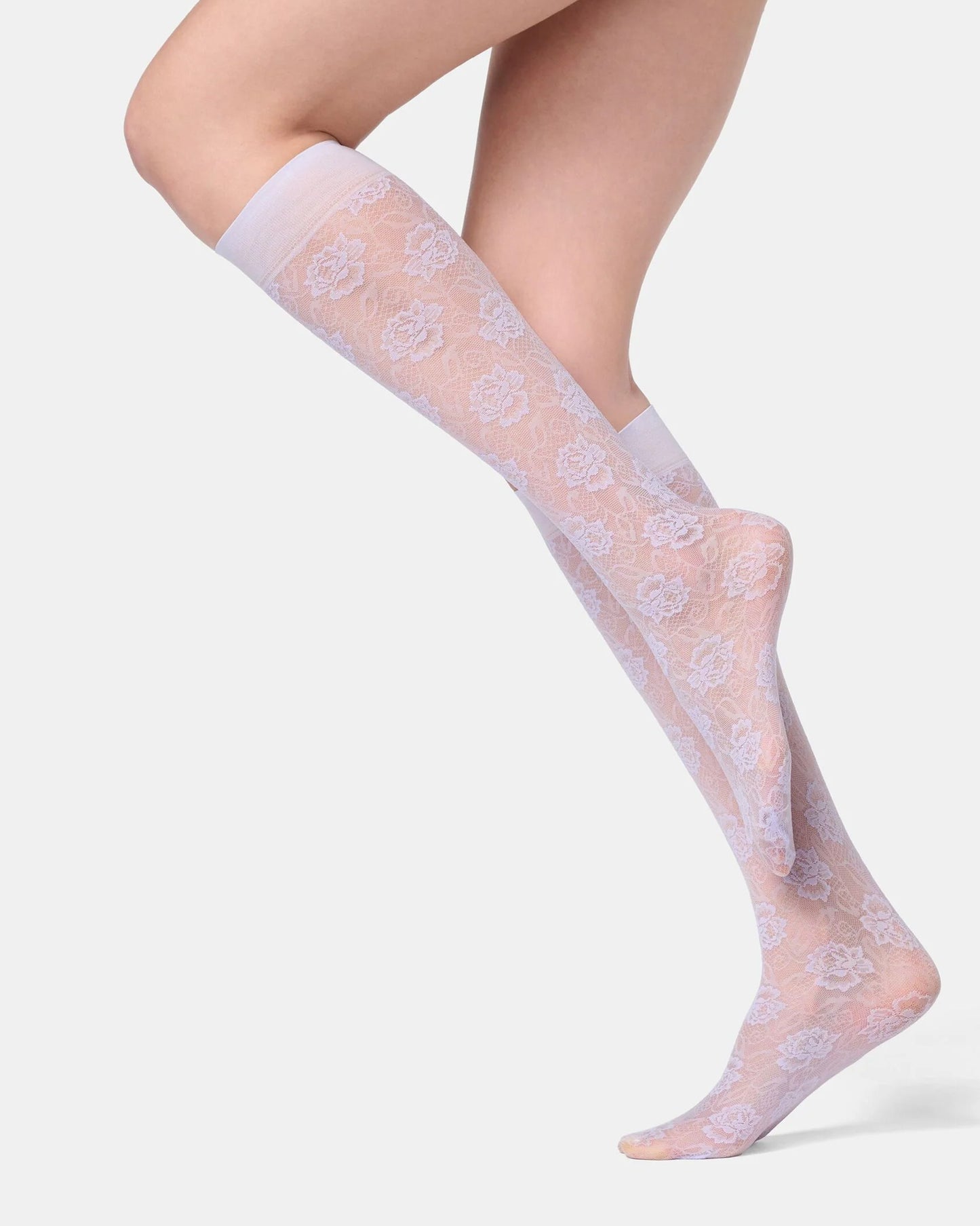 Sheer lilac floral patterned socks worn by a person on a light background