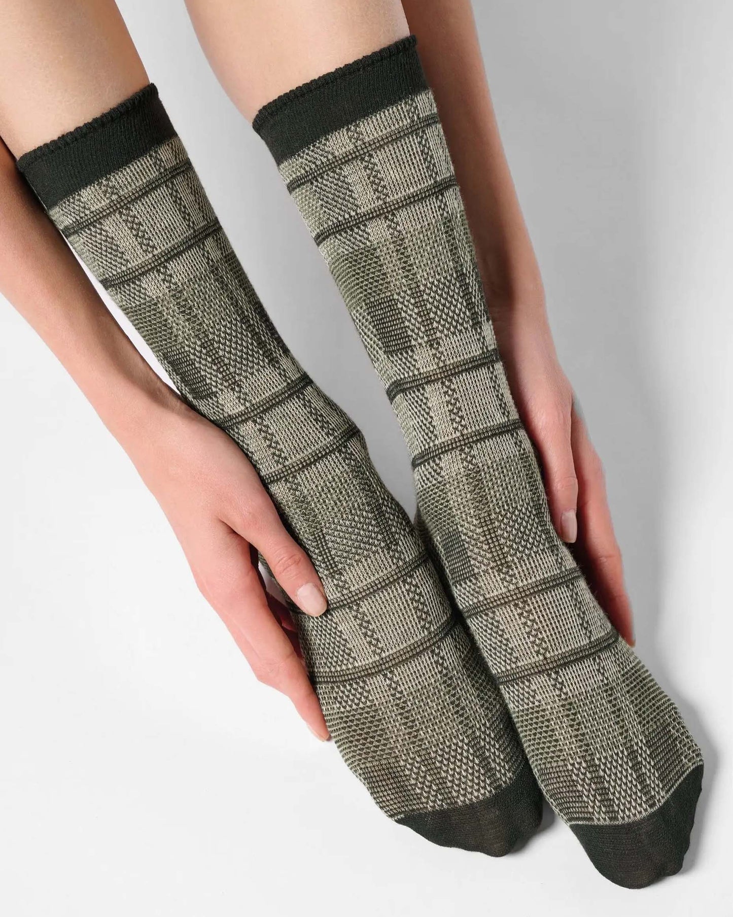 Light sage green ankle socks with a large tartan pattern, black toe and cuff.