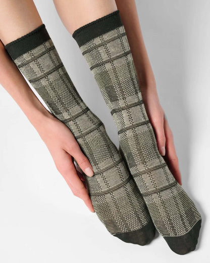 Light sage green ankle socks with a large tartan pattern, black toe and cuff.