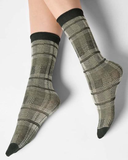 Light sage green ankle socks with a large tartan pattern, black toe and cuff.