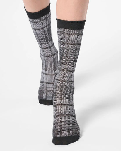 Light grey ankle socks with a large tartan pattern, black toe and cuff.