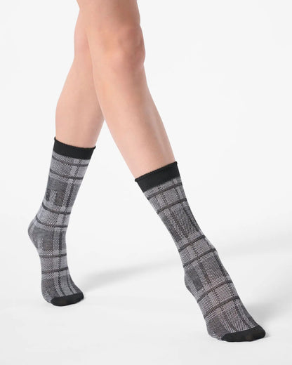 Light grey ankle socks with a large tartan pattern, black toe and cuff.