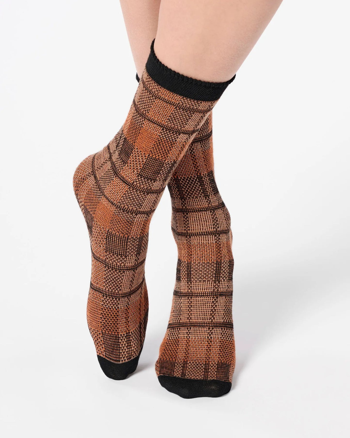 Rust orange ankle socks with a large tartan pattern, black toe and cuff.