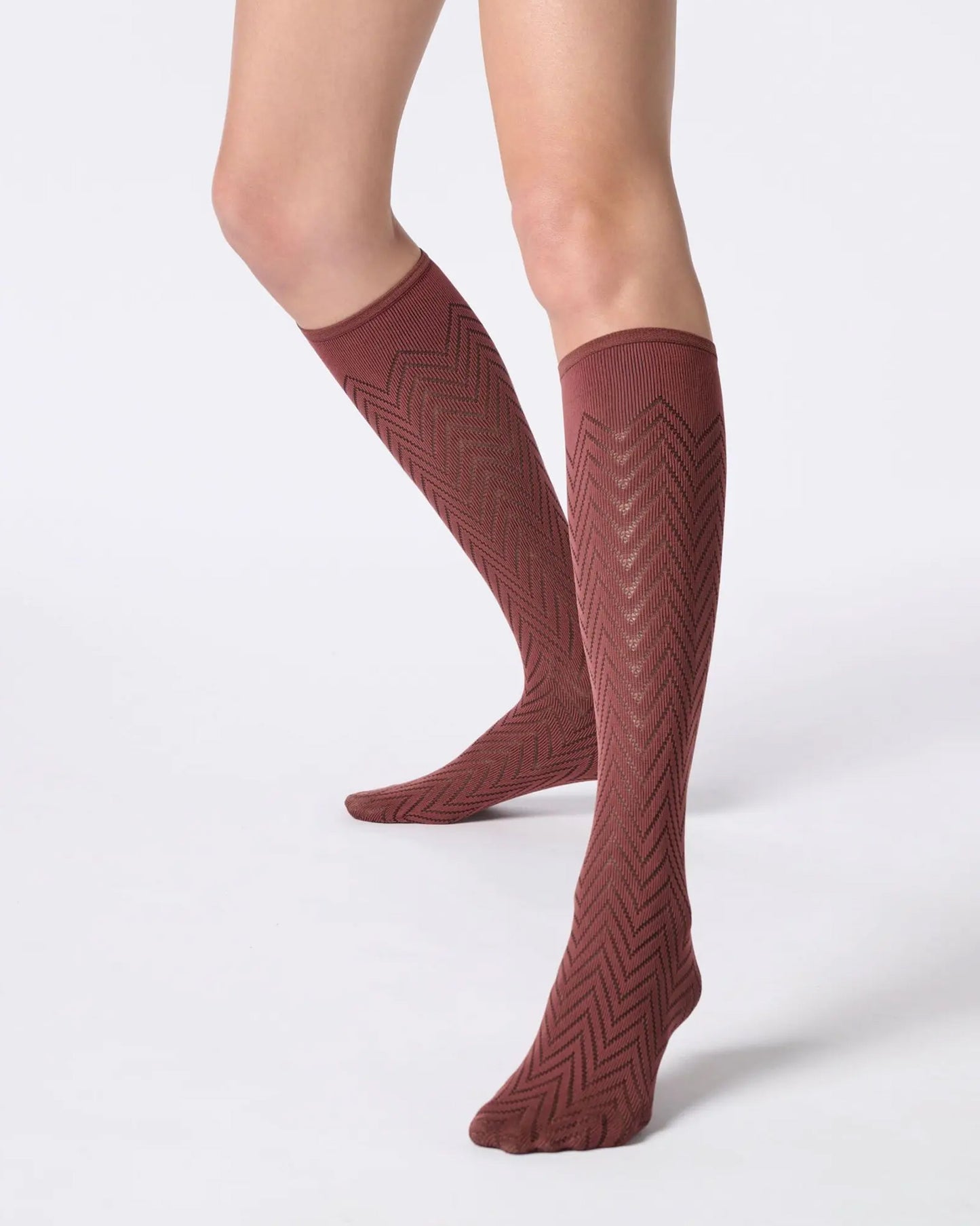 Maroon / brick red opaque knee-high socks with a zig-zag pattern.