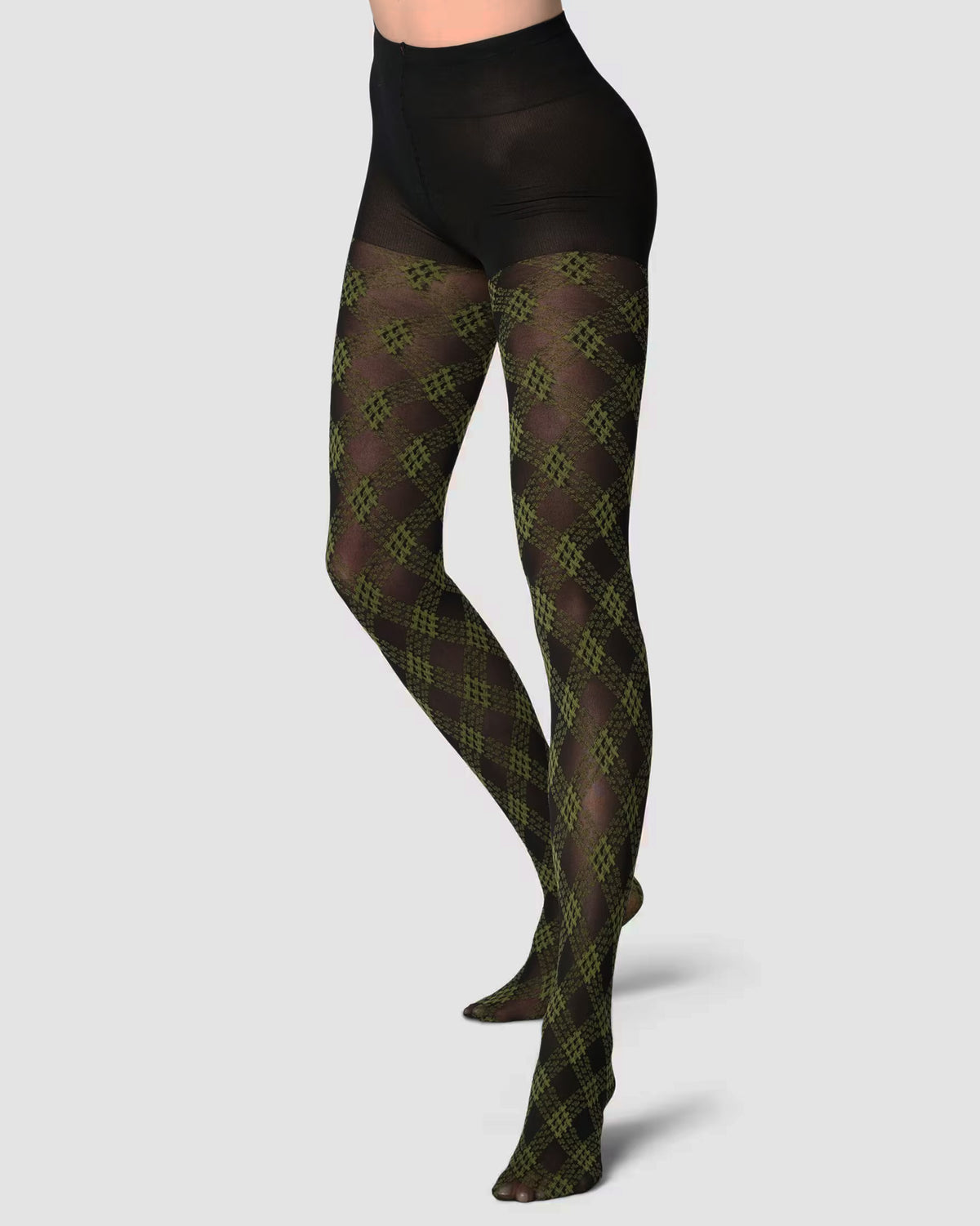 A model's lower body wearing sheer olive green and black argyle patterned tights with a solid black waistband, shown against a light gray background.