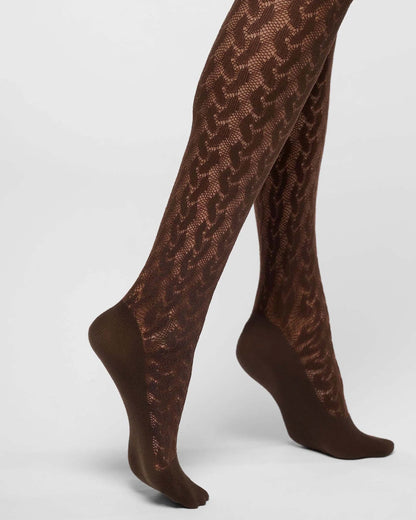 Brown lace tights with solid brown toe, heel, and sole sections, shown on a model's legs against a light gray studio background.