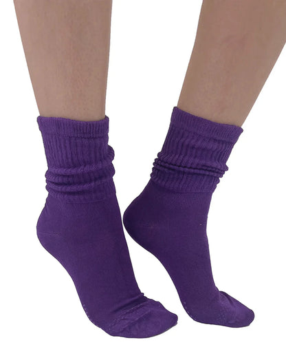 Purple socks worn by a person on a white background