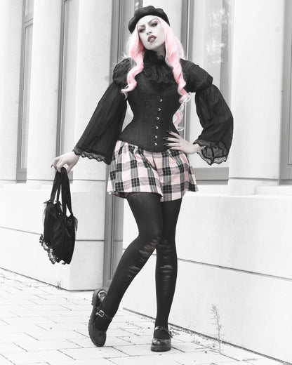A woman posing outdoors in a gothic style, featuring a black ruffled corset top with puffed sleeves, a pink and black plaid mini skirt, black tights, a black beret, and holding a black handbag.