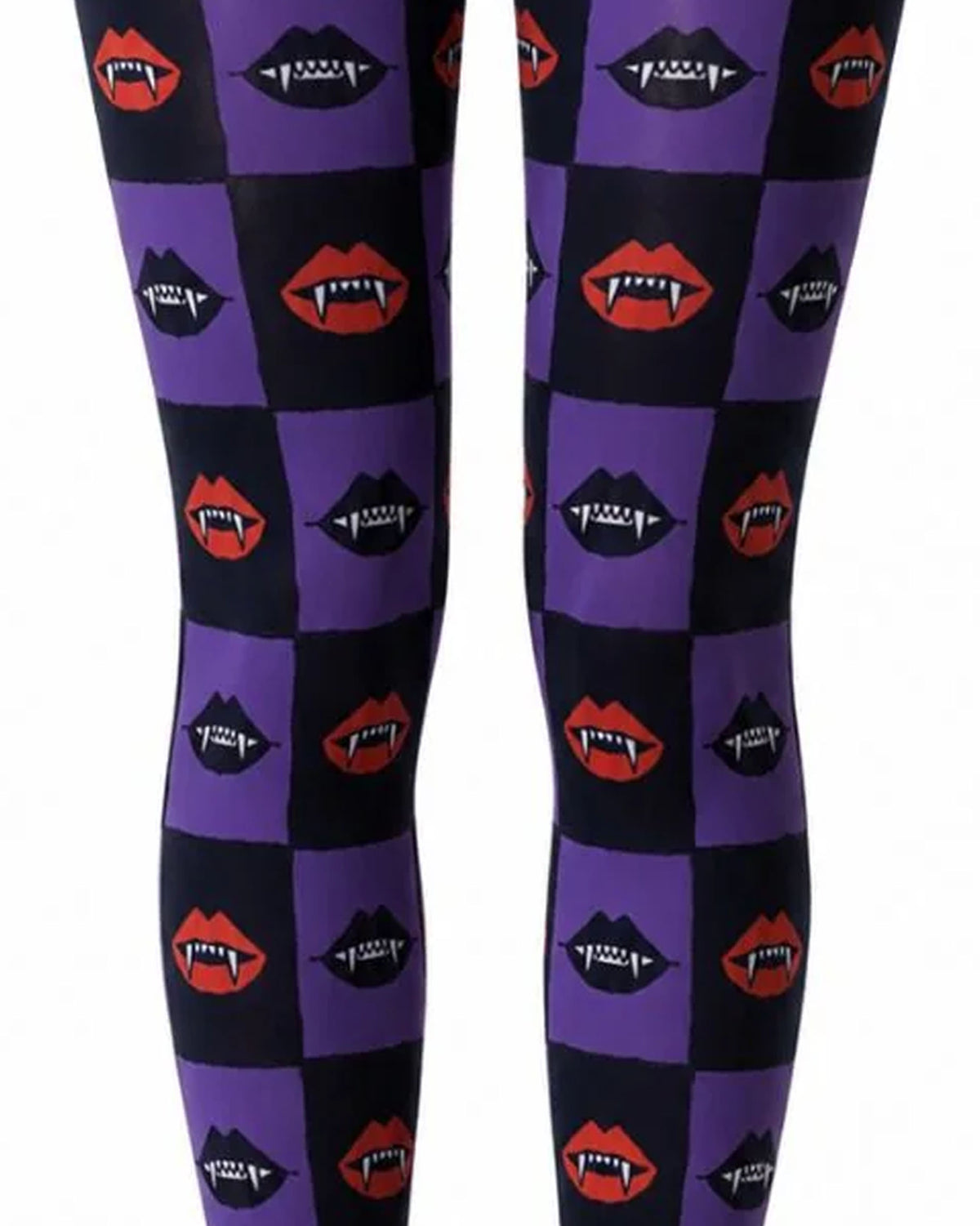 Close up of black and purple checkered print Halloween tights with vampire mouths with fangs