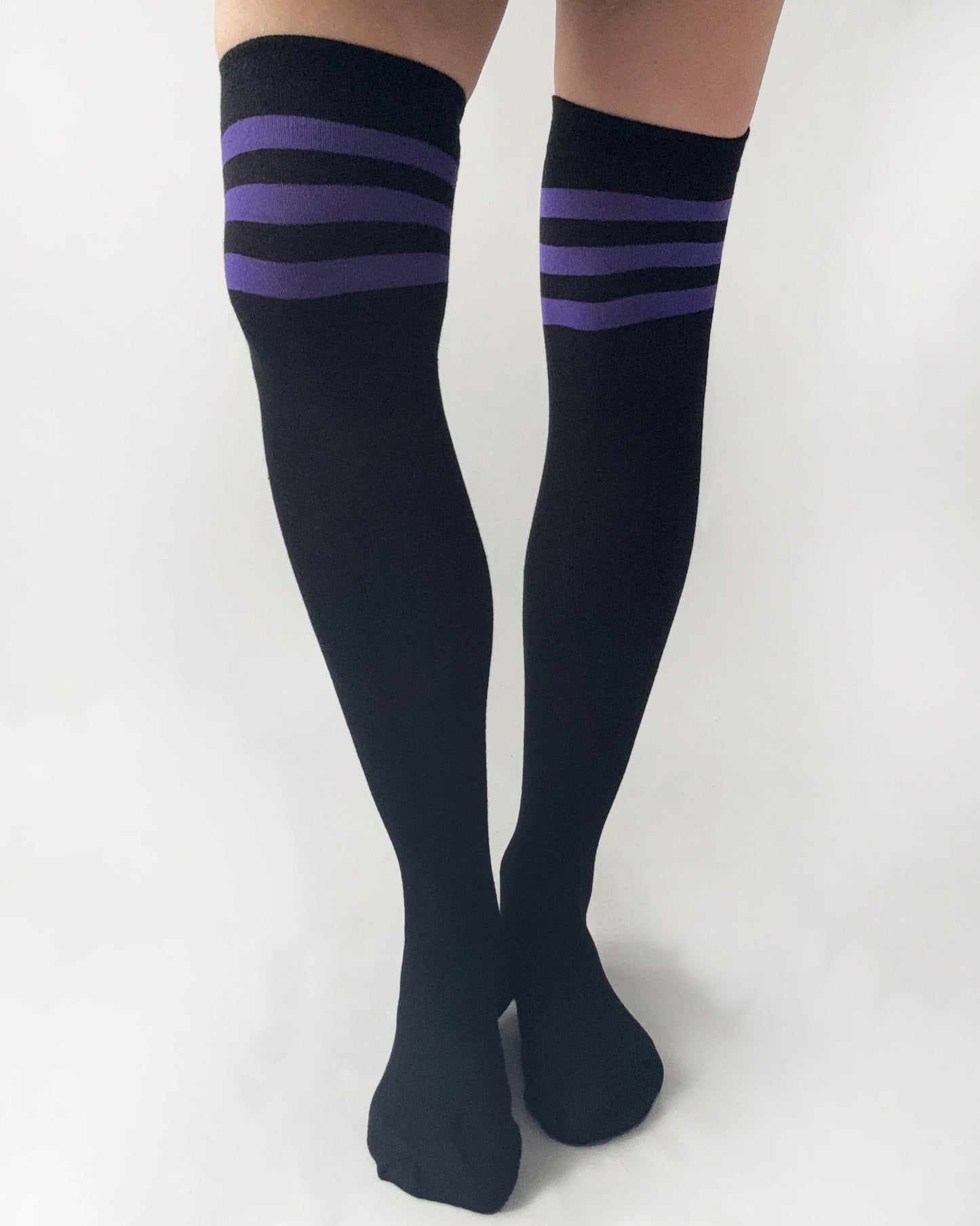 Black knee-high socks with purple stripes on a white background