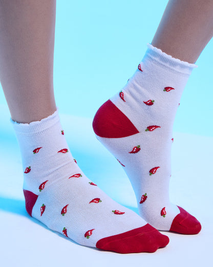 White socks with red chili pepper pattern on a light blue background