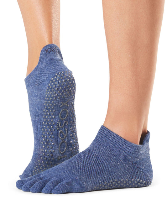 Blue toe-separated socks with grip dots on a white background