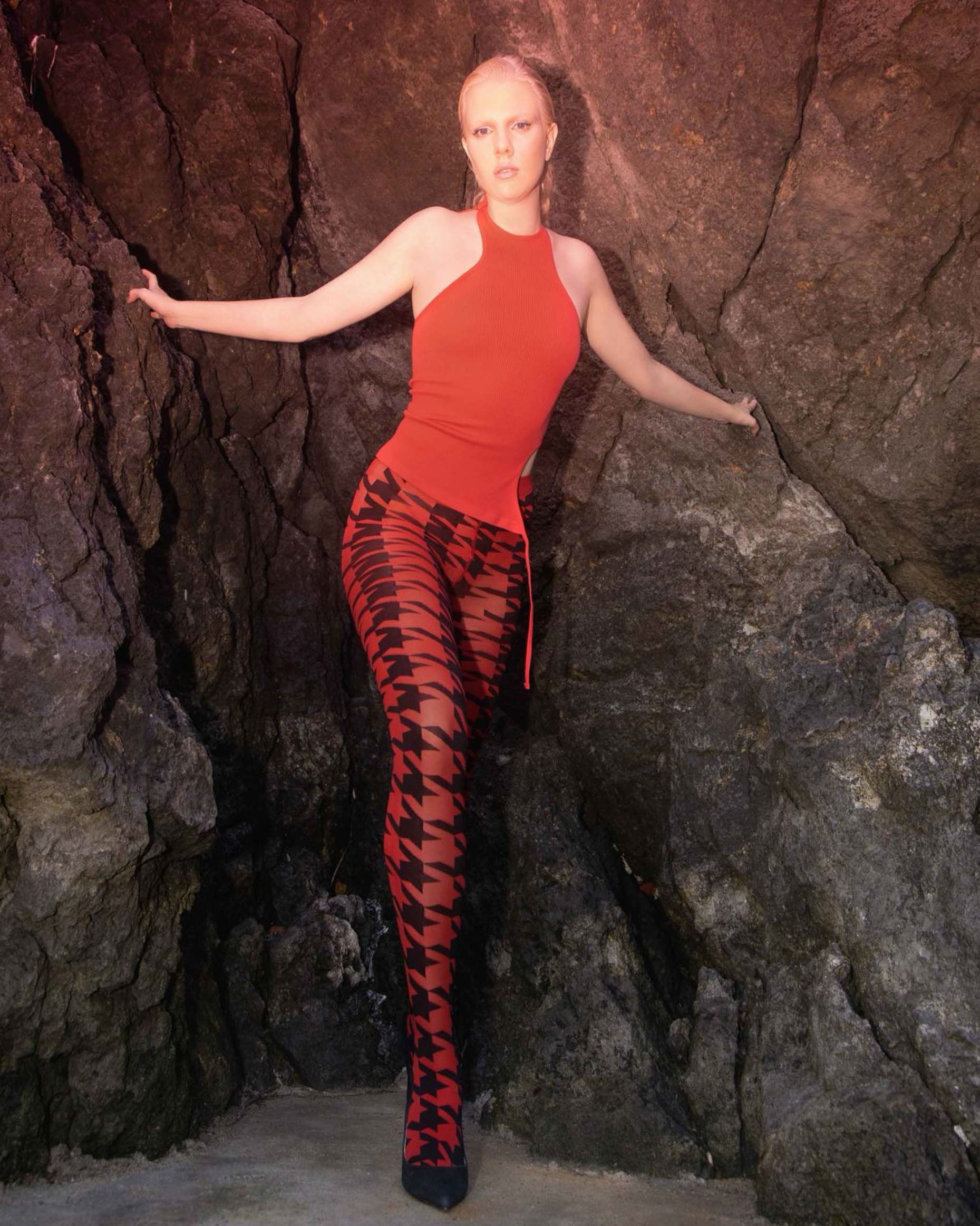 Trasparenze Copernicus Collant - Red opaque fashion tights with a bold and large black houndstooth pattern with contrasting colour. Worn with red halter neck top
