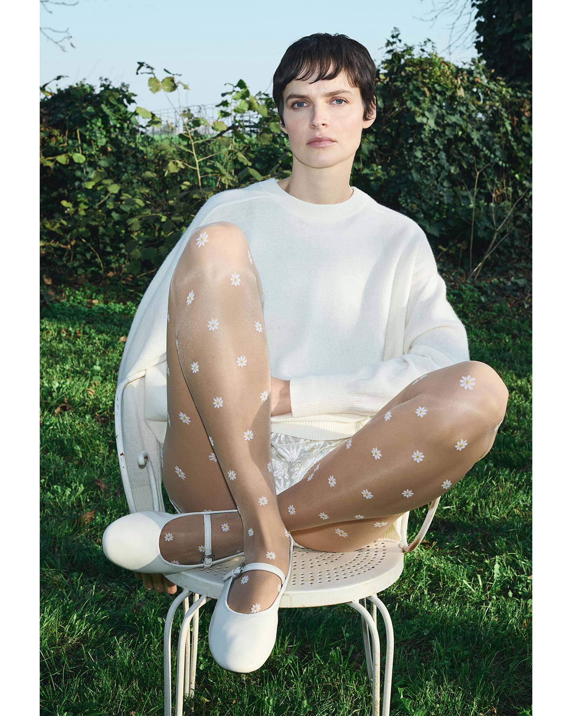Trasparenze Millibar Collant - Sheer nude fashion tights with an all over woven pattern of daisy flowers. Worn with white pumps, lace shorts and sweater.