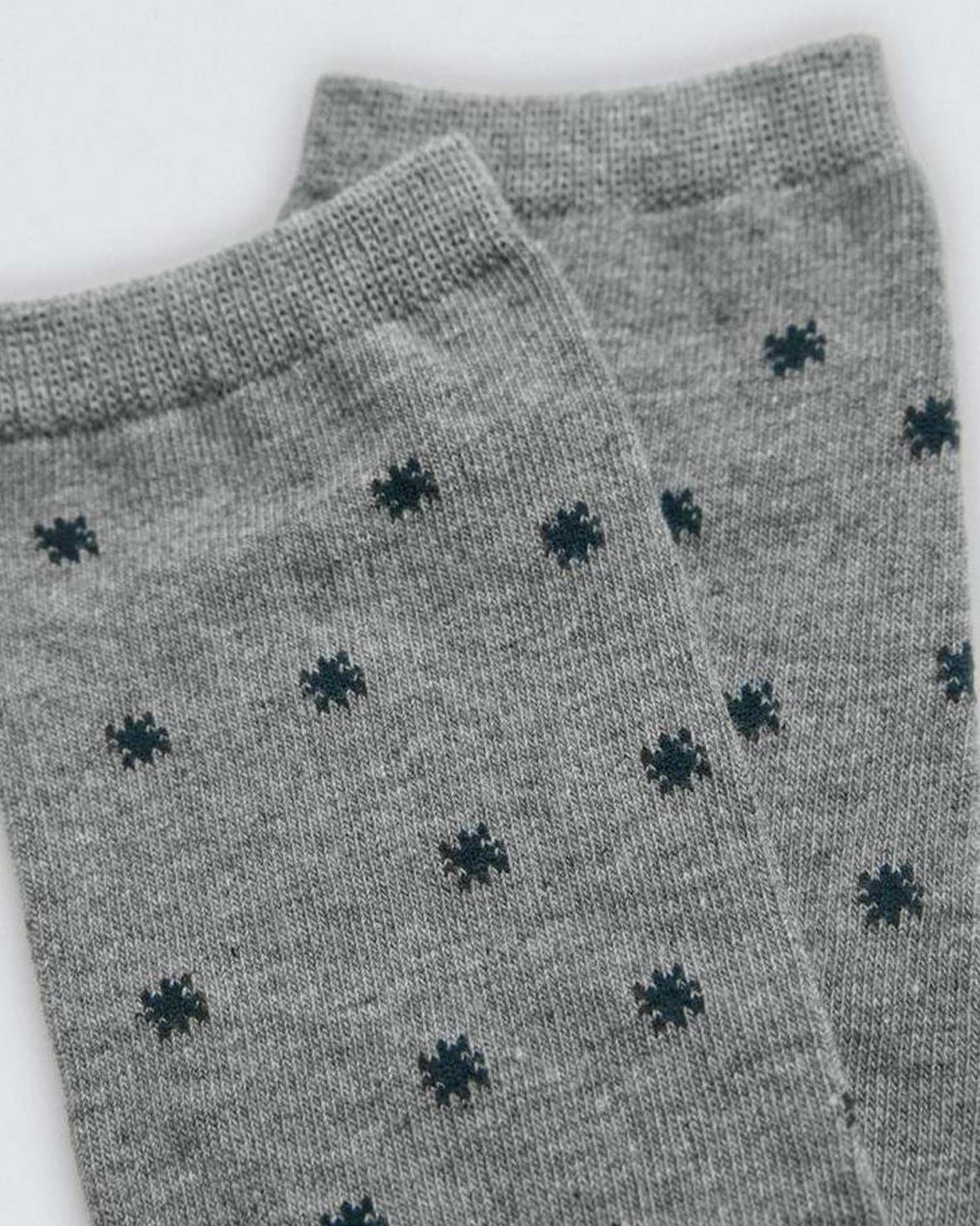 Grey socks with black pattern on a white background