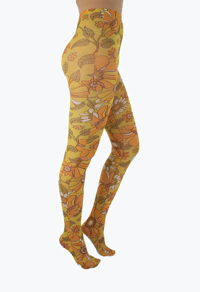 Pamela Mann Throwback Flower Tights - Cream opaque tights with a sixties style flower print pattern in bright shades of mustard and orange, outlined in brown.