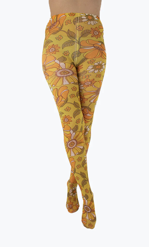 Pamela Mann Throwback Flower Tights - Cream opaque tights with a sixties style flower print pattern in bright shades of mustard and orange, outlined in brown.