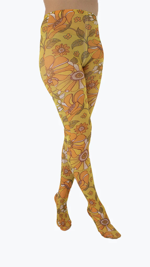 Pamela Mann Throwback Flower Tights - Cream opaque tights with a sixties style flower print pattern in bright shades of mustard and orange, outlined in brown.
