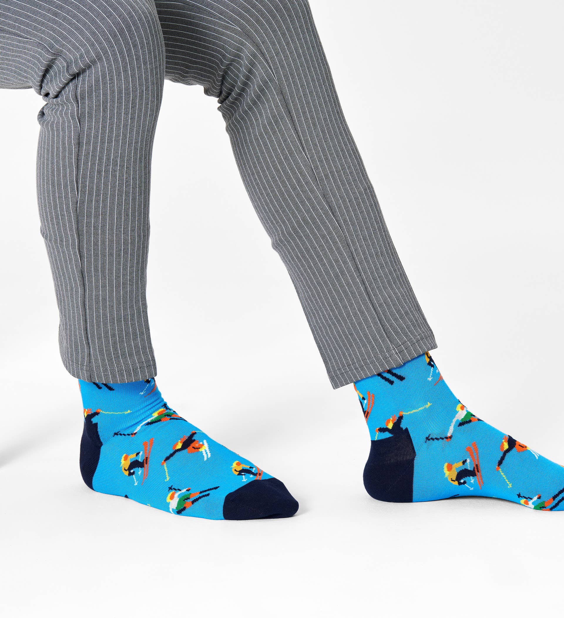 Happy Socks SKI01-6300 Skiing Sock - Sky blue cotton ankle socks with multicoloured jumping skiers, dark navy cuff and toe. Perfect Christmas gift.