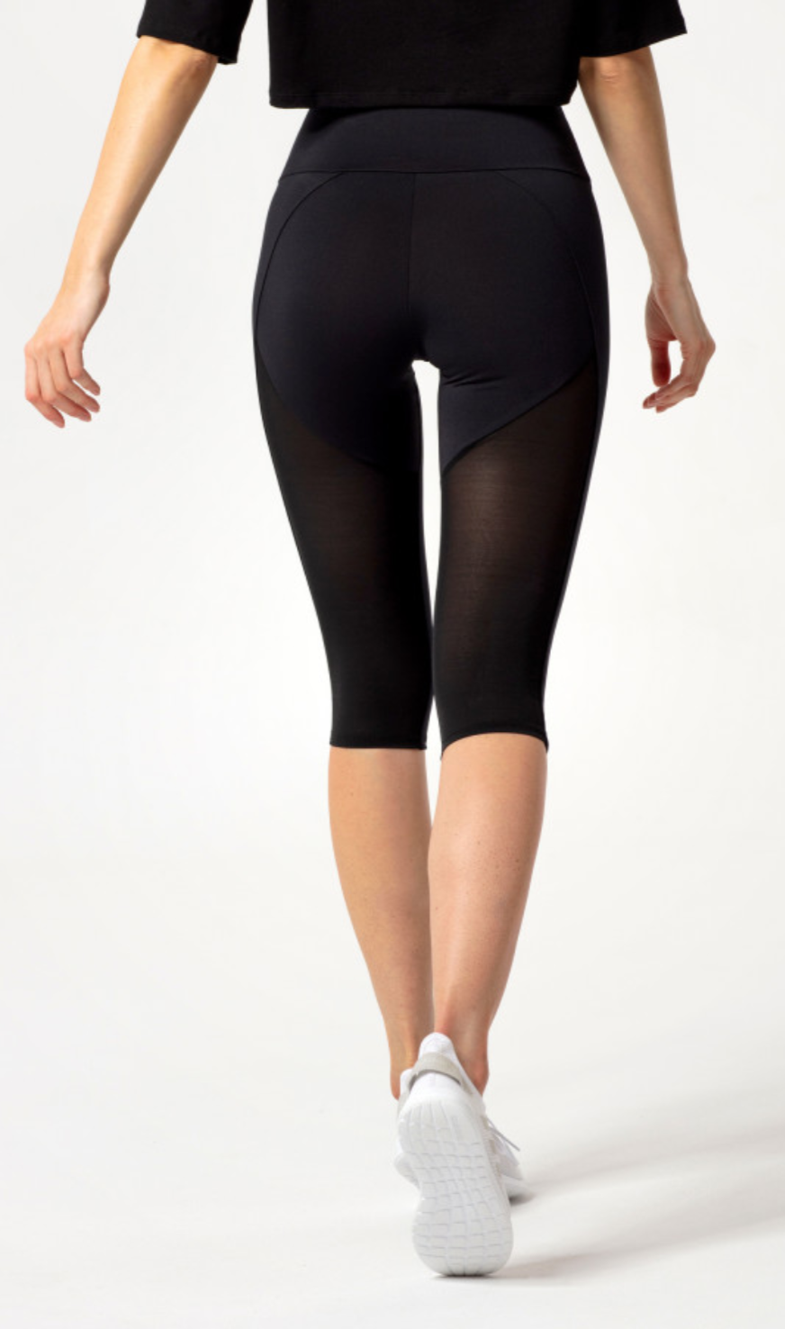 Carpatree Hyperion Tulle Capri Leggings - Black high waisted 3/4 length leggings with mesh panels at the back of the legs.