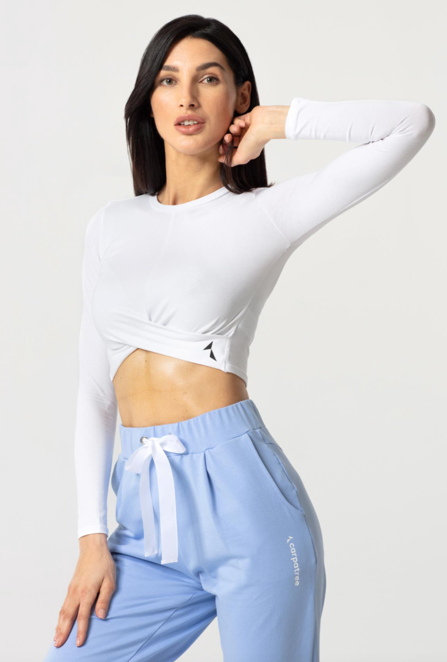 Carpatree Gaia Longsleeve Top - White cropped long sleeve sports top with twist detail. Made of soft cotton.